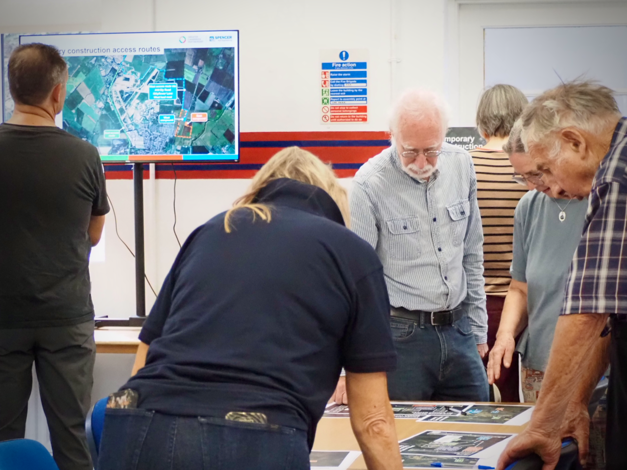 Attendees looking at maps and a presentation at the Waterbeach station open day